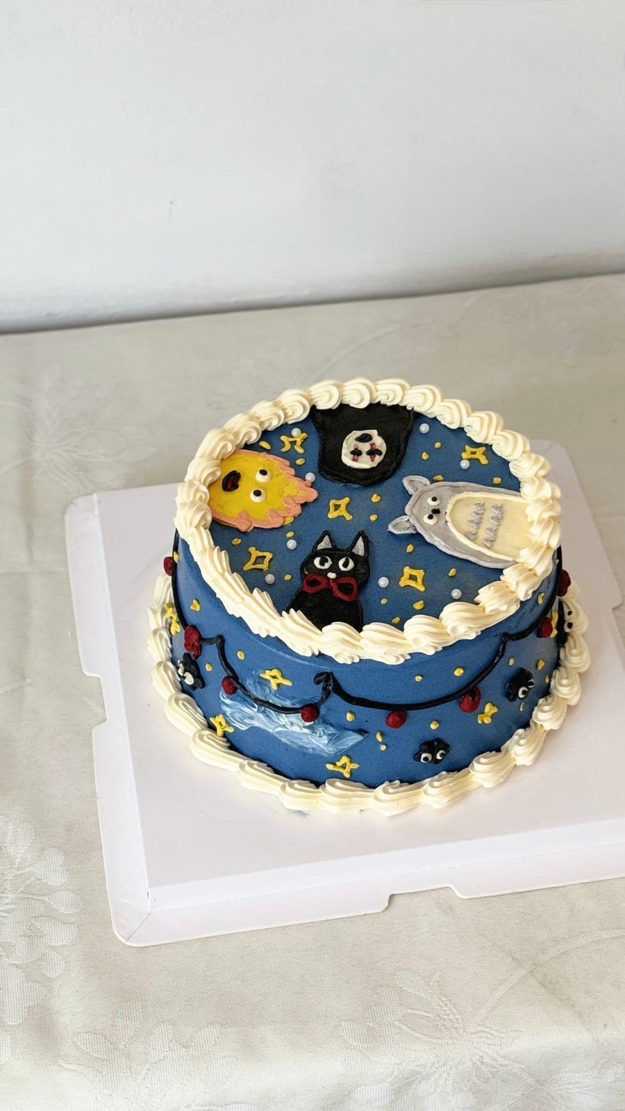 Night sky bento cake with piped stars and characters